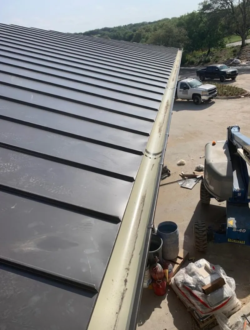 Standing seam panel and gutter detail on a metal roofing jobsite in Linganore